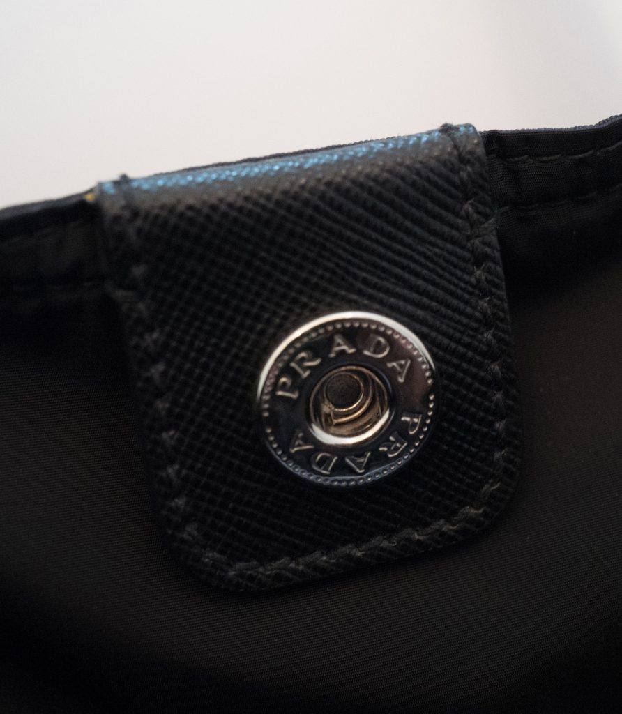 Prada logo button inside tote bag